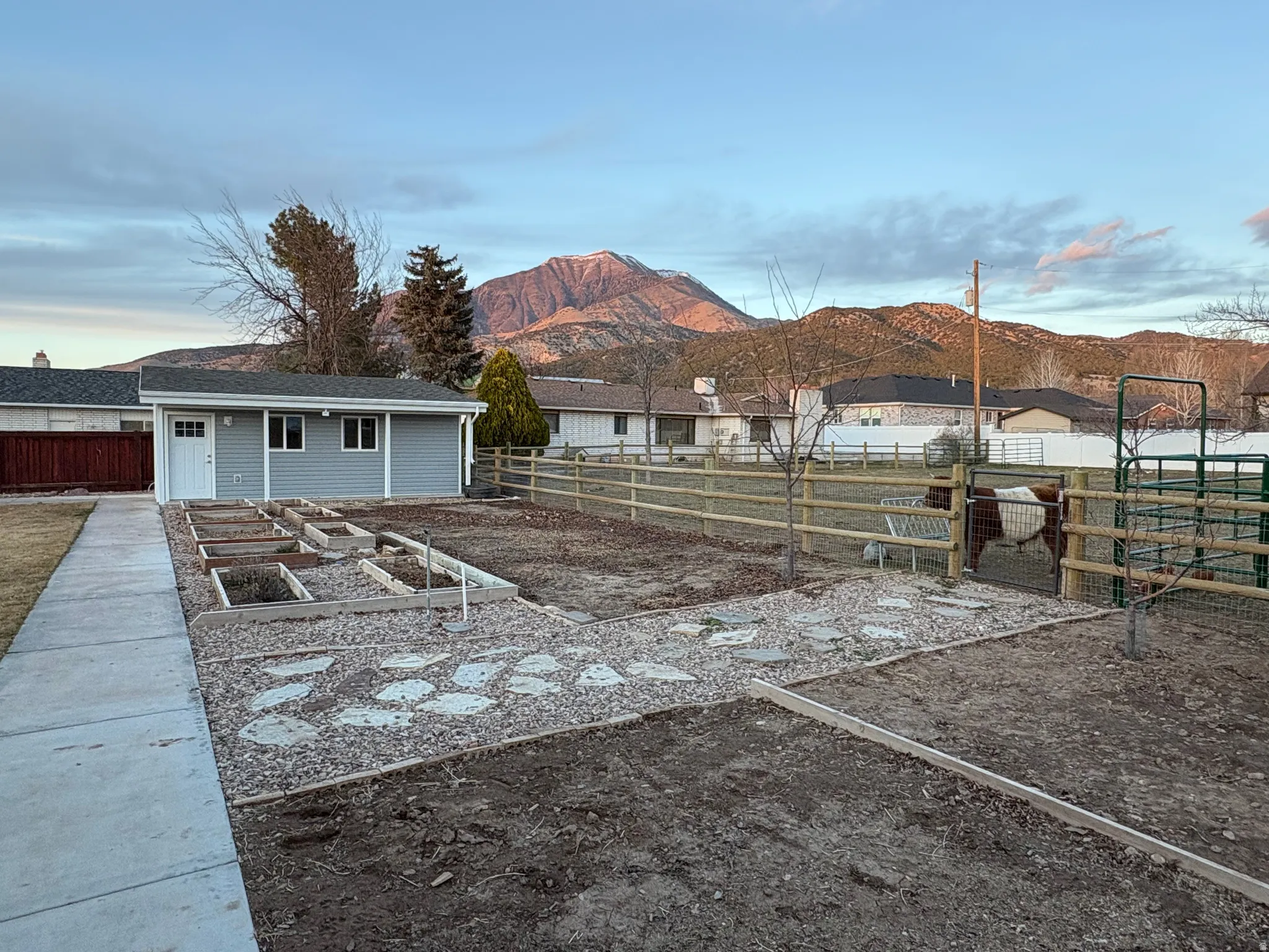 View of new fence, new shed, new garden plots, a new concrete pathway, and a beautiful view out toward the Juab "J".