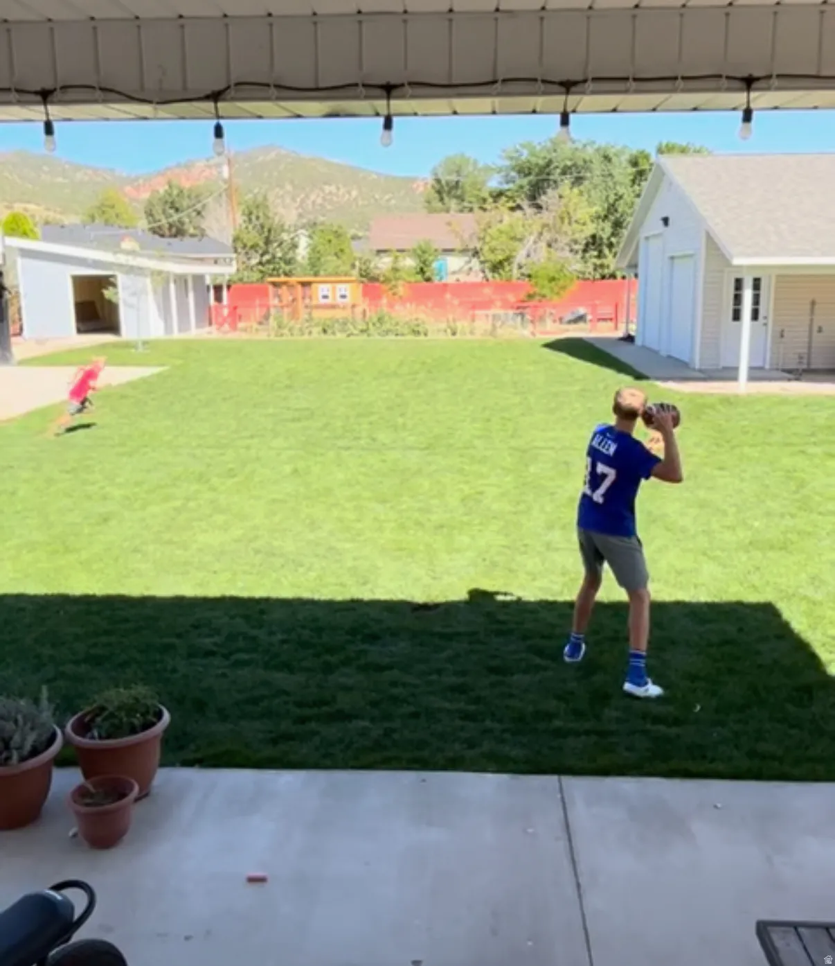 View of yard in the Summer, view looks East to the mountains. New landscaping and sprinkler system.