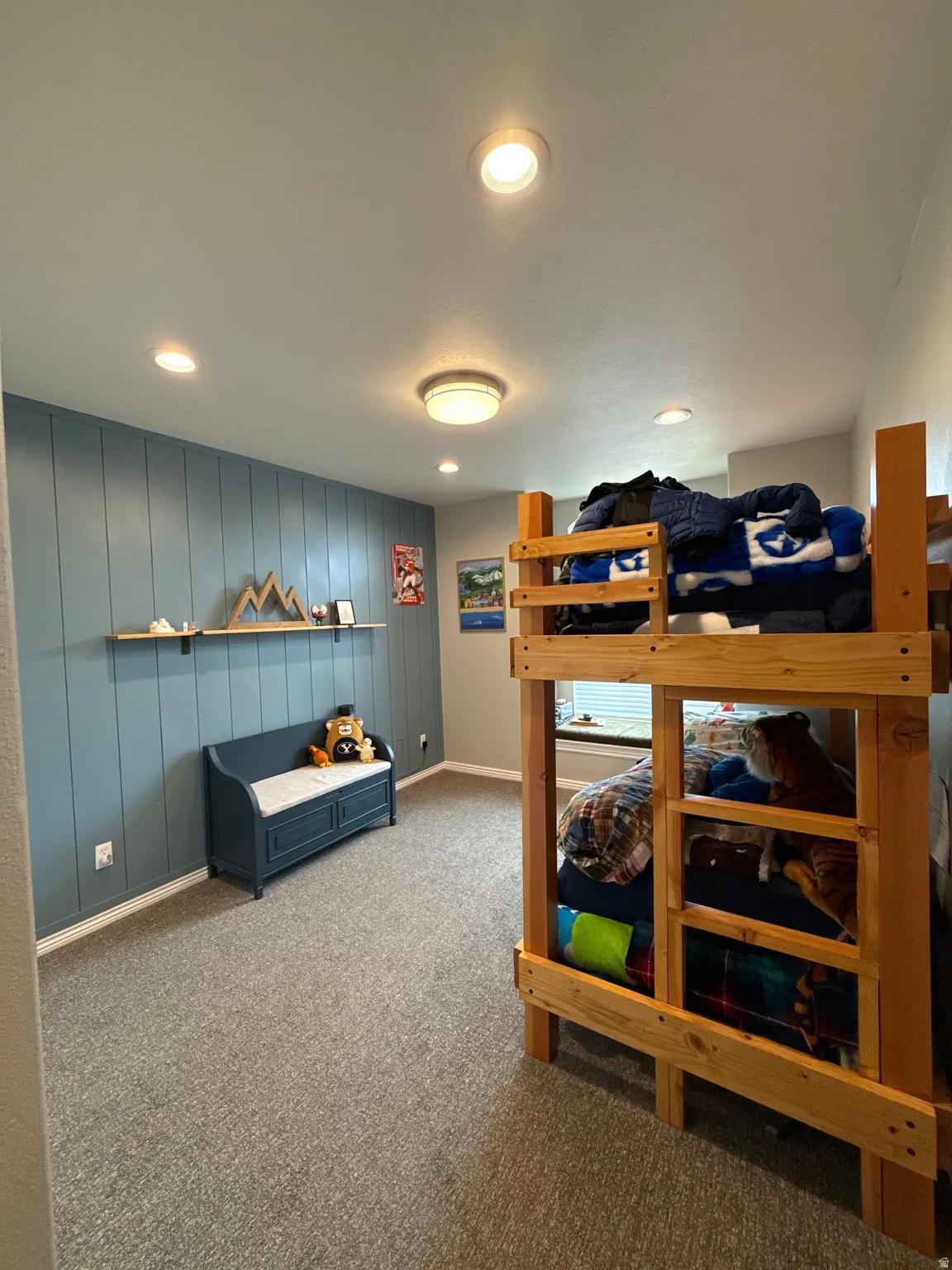 Bedroom 2 featuring upgraded carpet, an accent wall, recessed lighting, updated closet doors, and a bay box window.