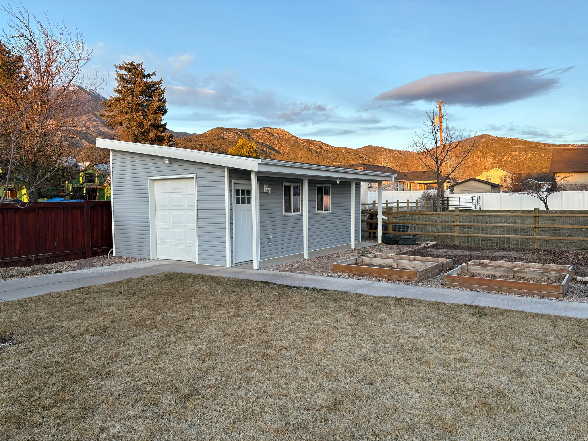 New storage shed with electricity and insulation, next to new concrete path that goes around the backyard area for bikes, walks, etc.