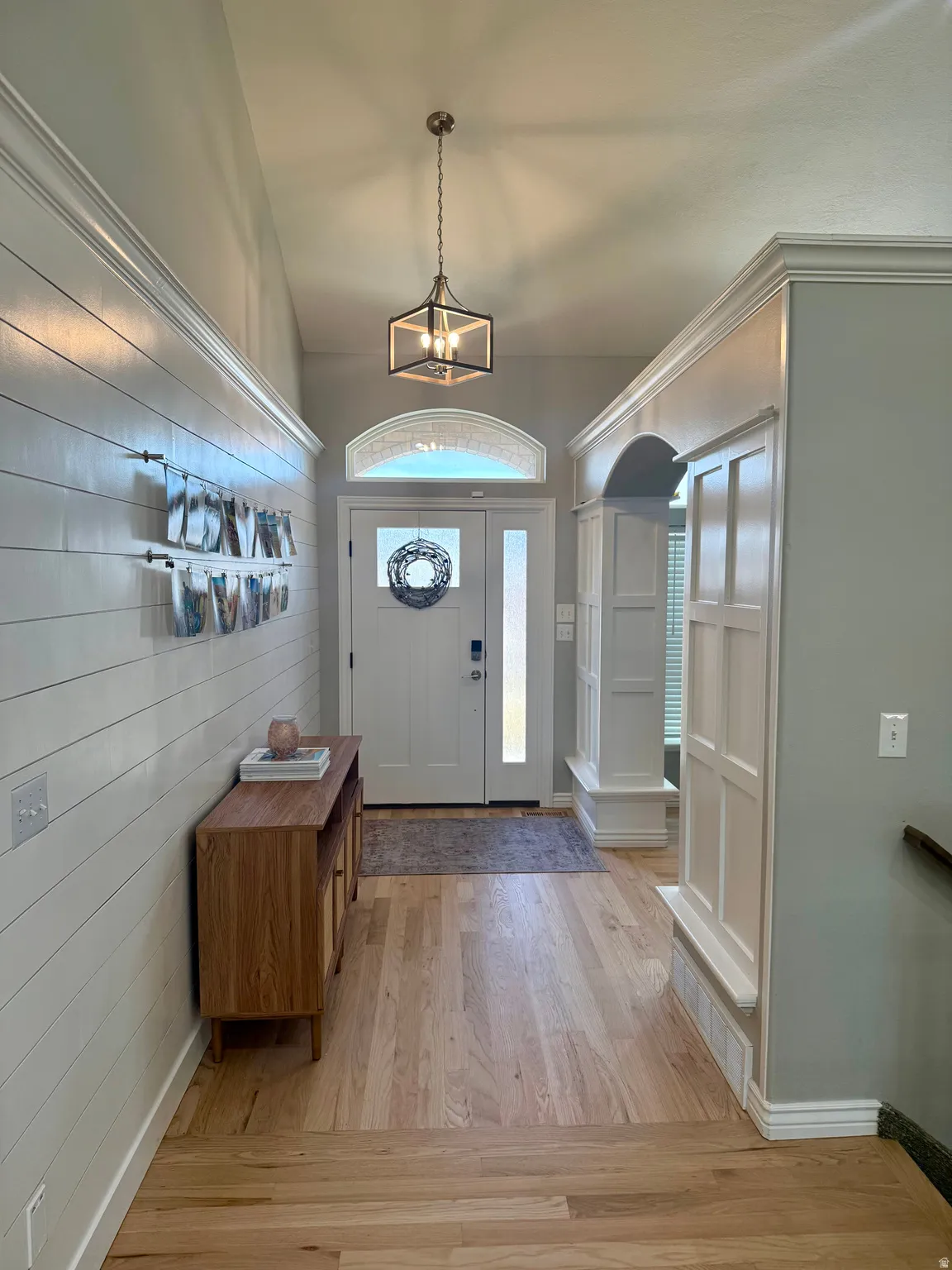 Foyer entrance with recently refinished hardwood floors.