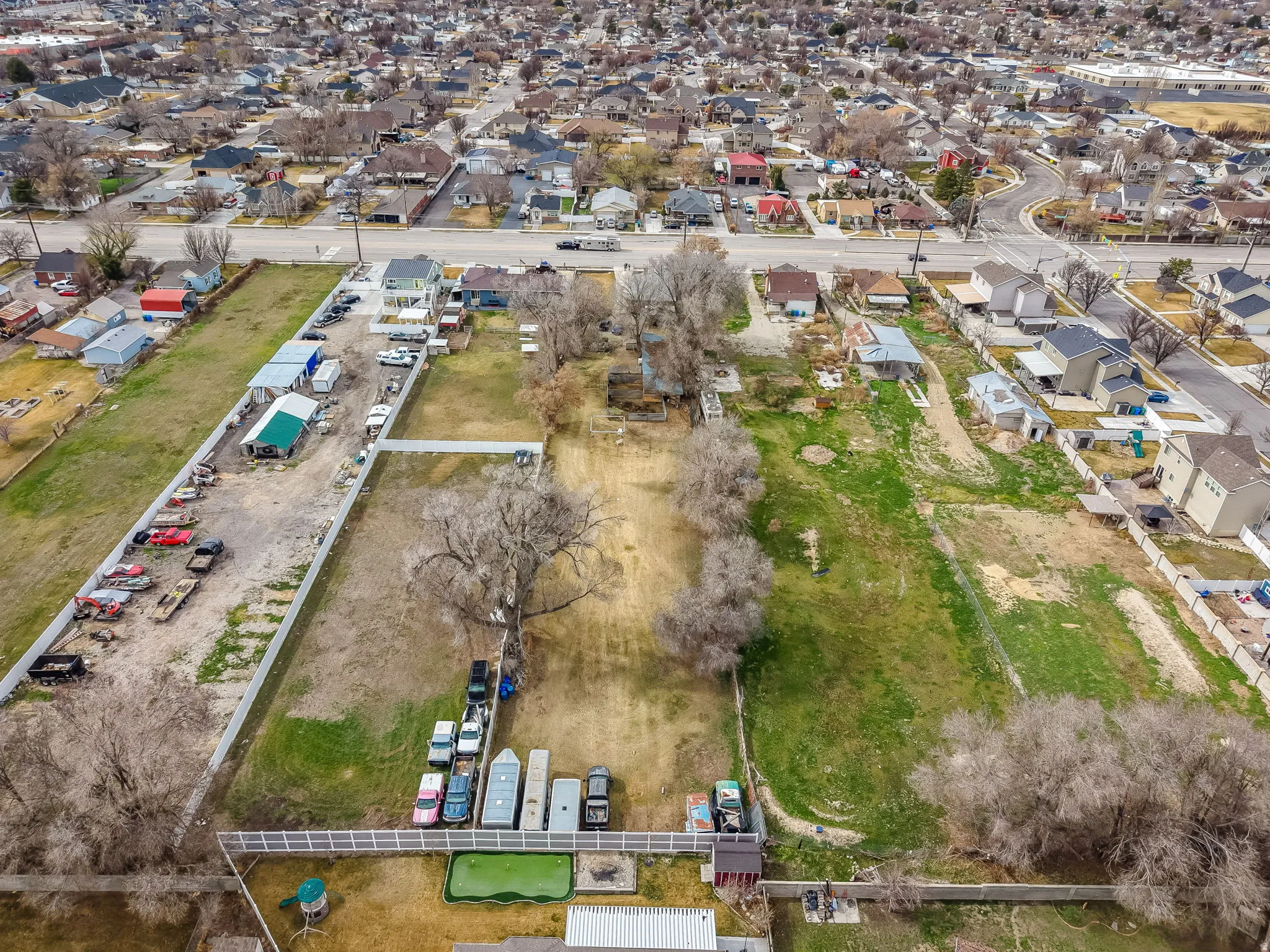 Aerial view of property and surrounding area with nearby suburban area