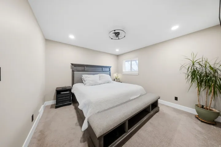 Bedroom featuring light colored carpet and recessed lighting