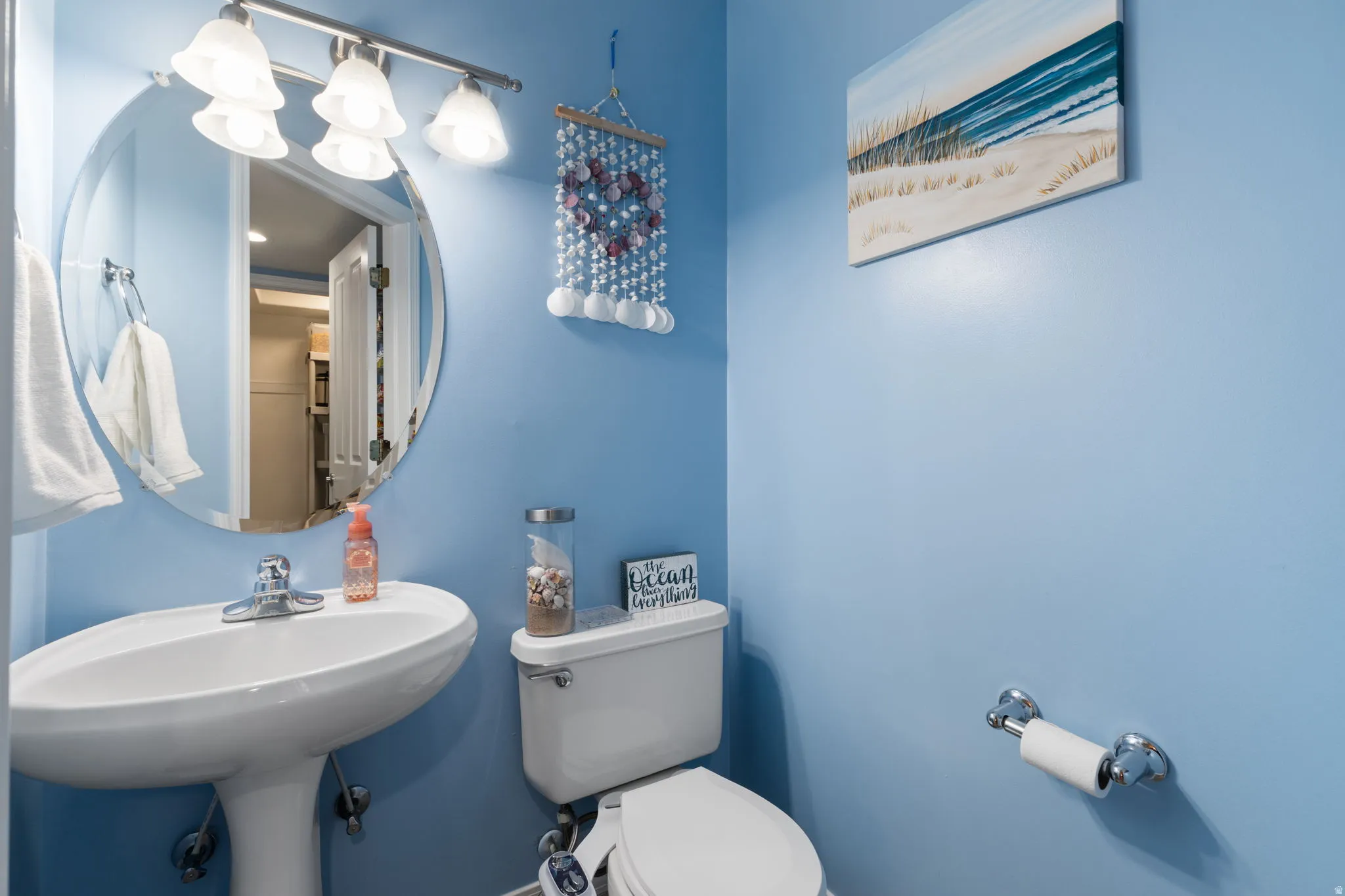 Half bathroom featuring toilet and a sink