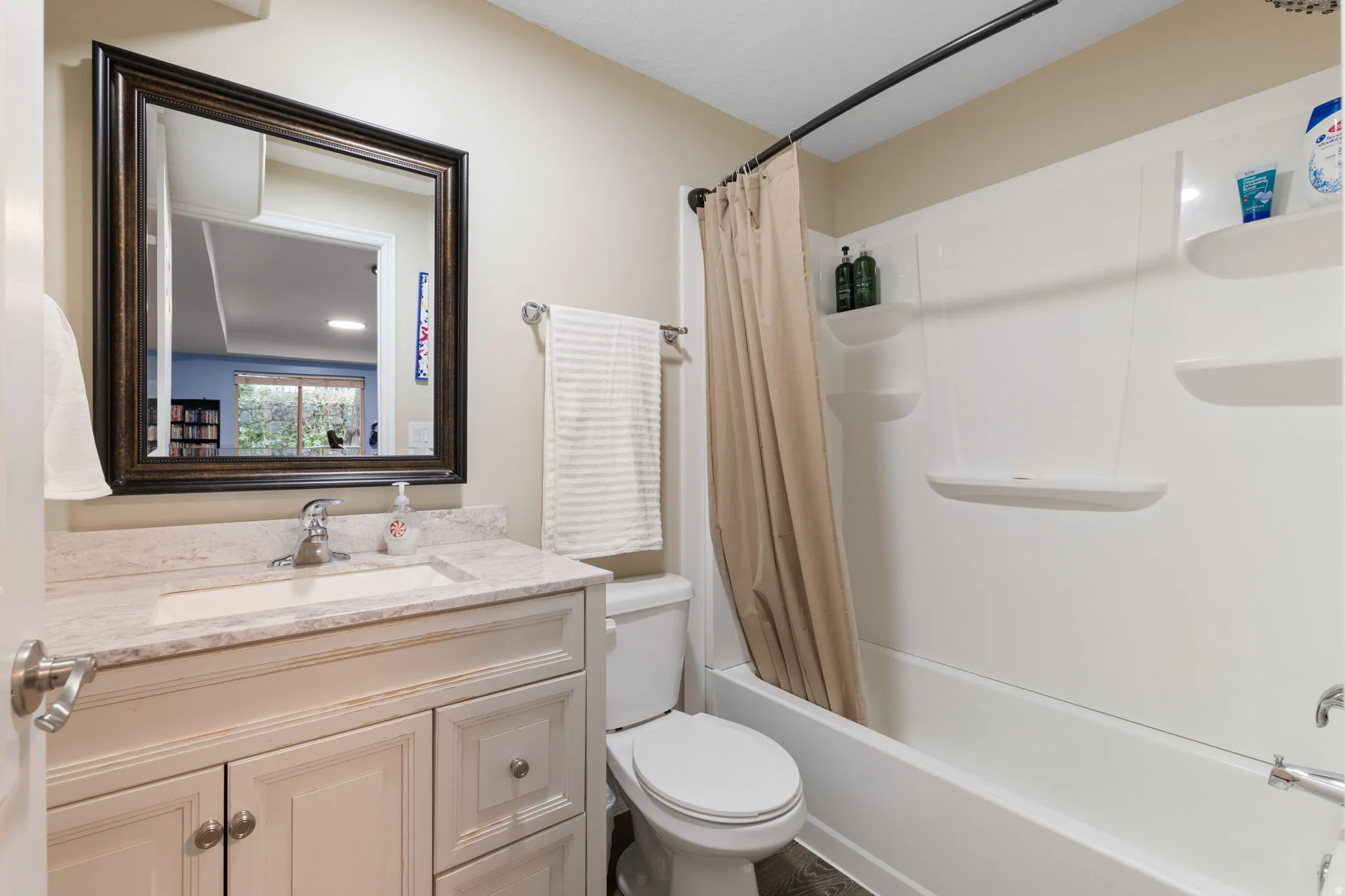 Full bath featuring vanity and shower / bath combination with curtain