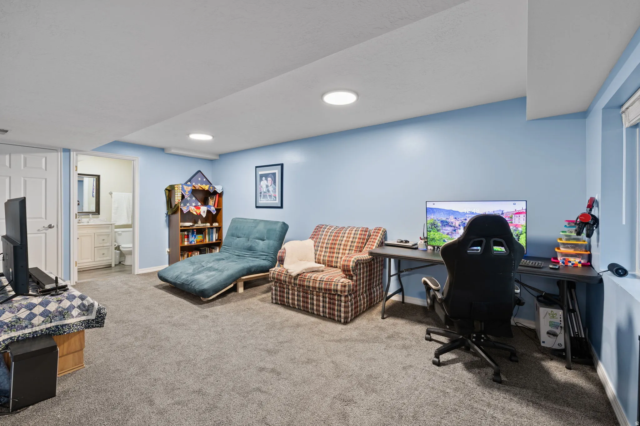 Living/Office space with light carpet and baseboards