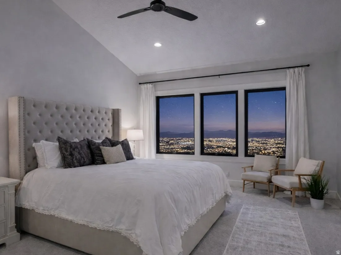 Bedroom with vaulted ceiling and a ceiling fan