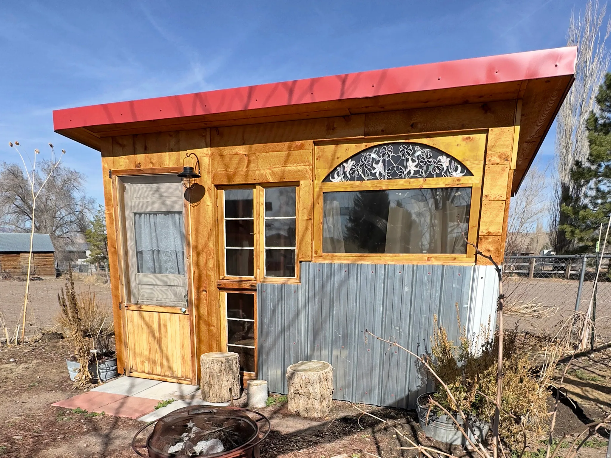 View of outbuilding featuring an outdoor fire pit