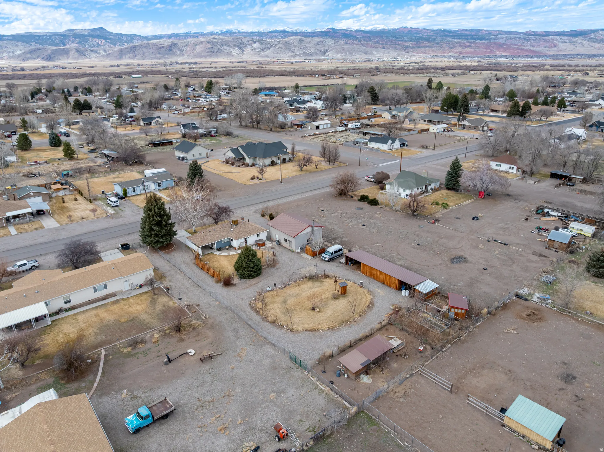 Aerial view of property's location with a mountainous background and nearby suburban area