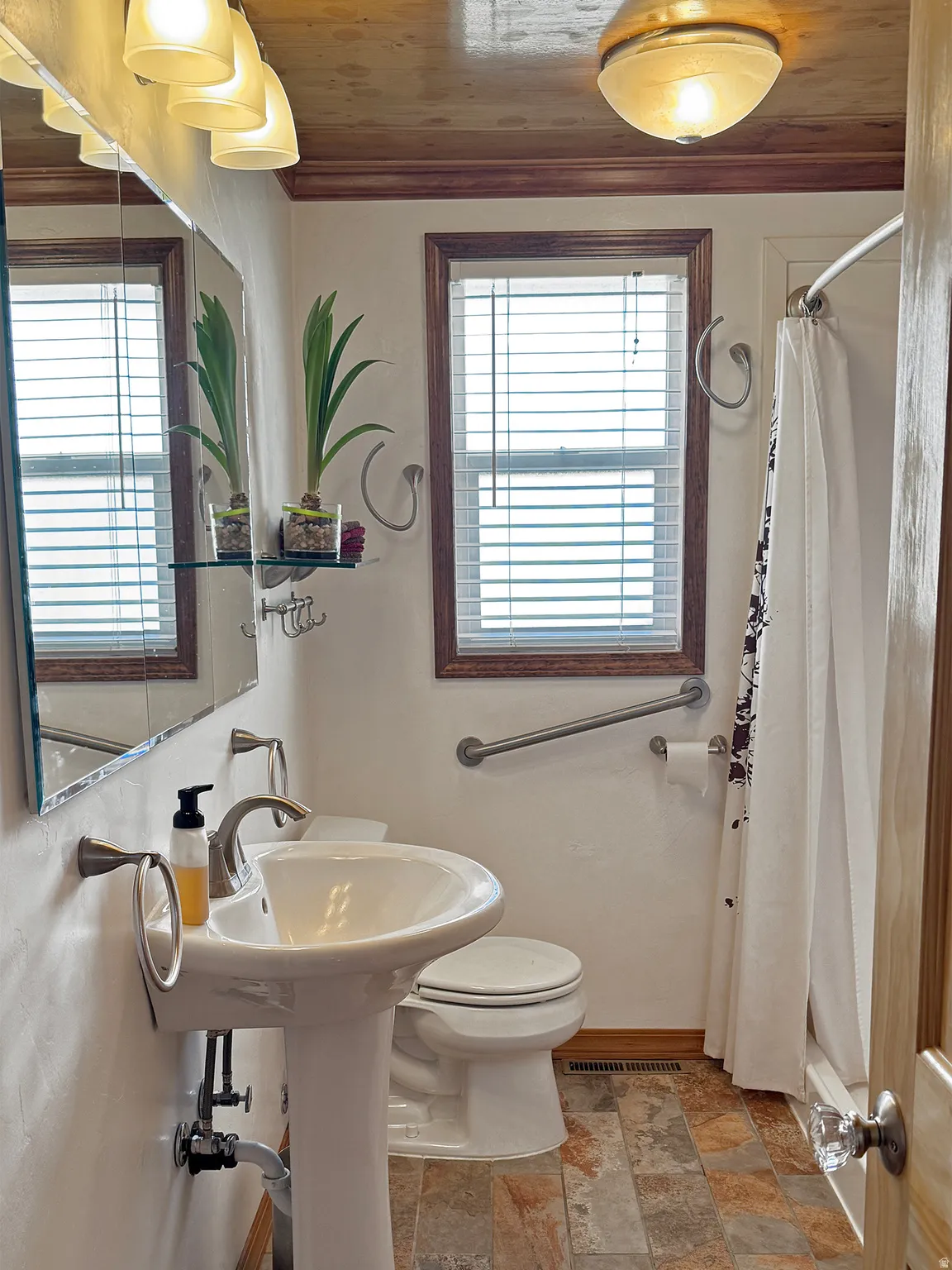 Full bathroom with toilet and wooden ceiling