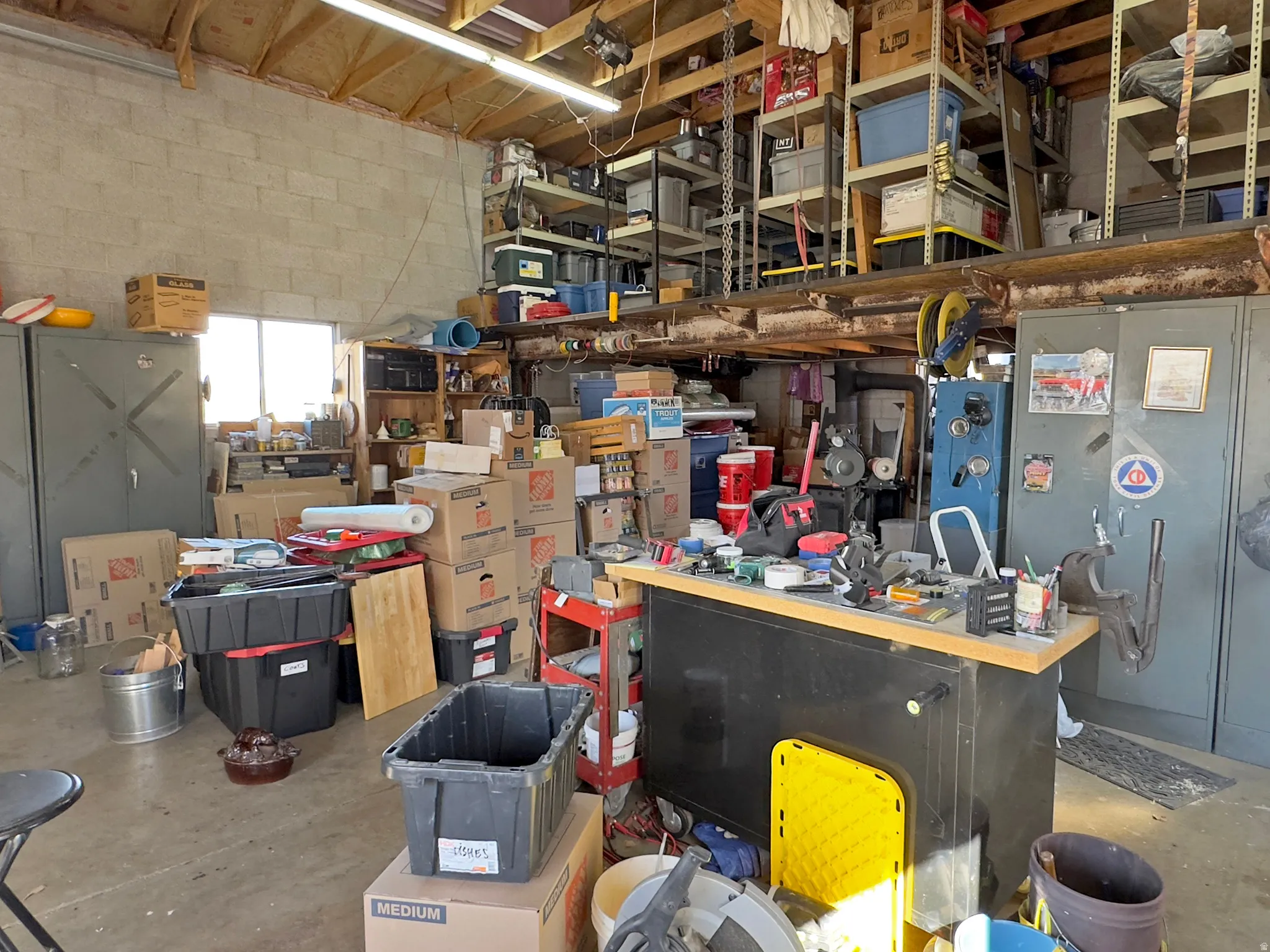 Garage with concrete block wall and a workshop area