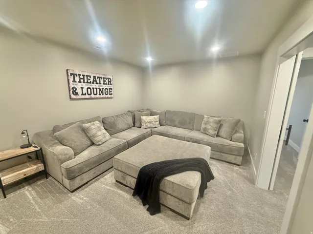 Carpeted living room featuring baseboards and recessed lighting
