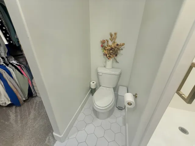 Bathroom with toilet and light tile patterned floors