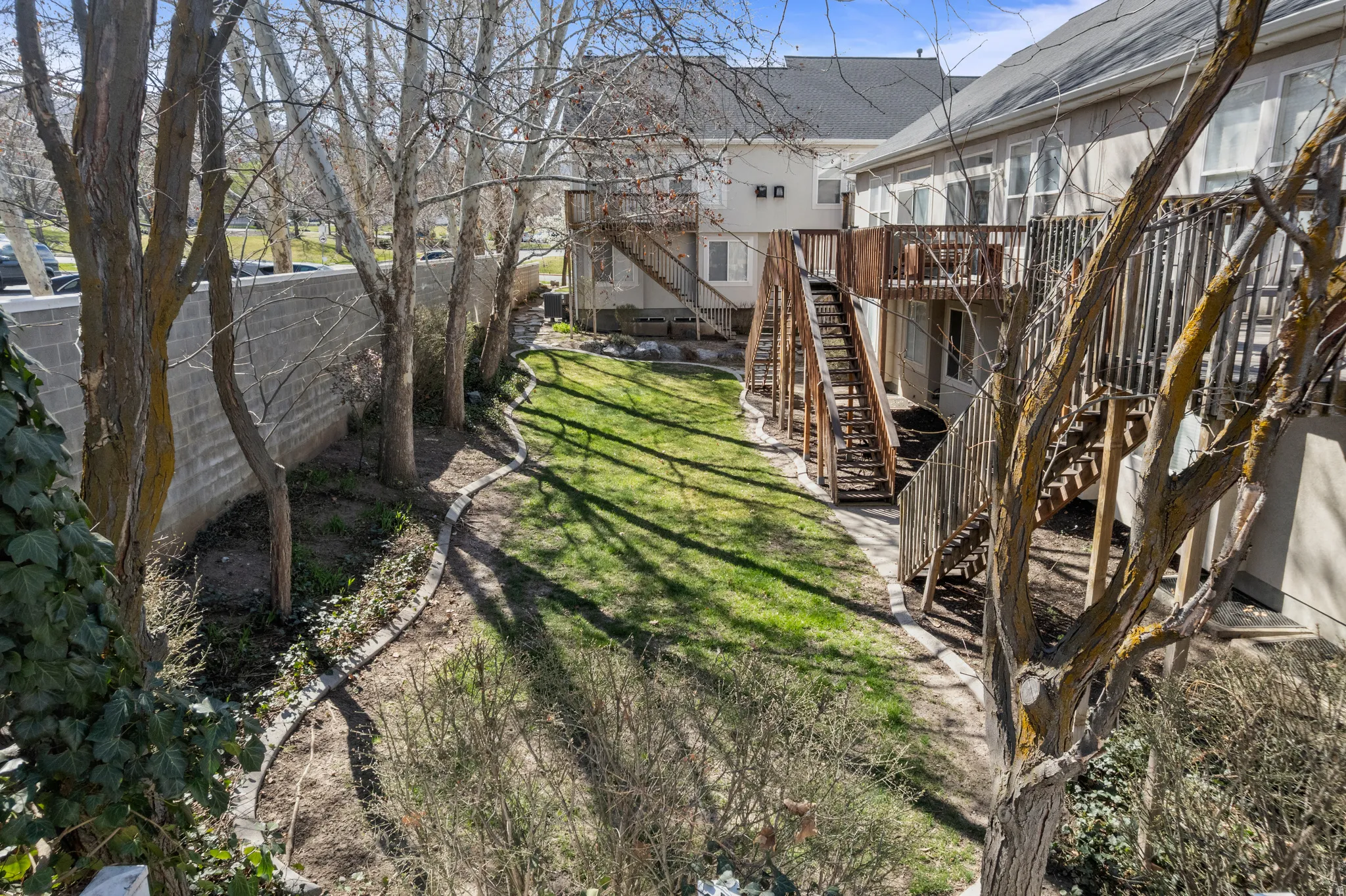 Fenced yard featuring a wooden deck and stairs