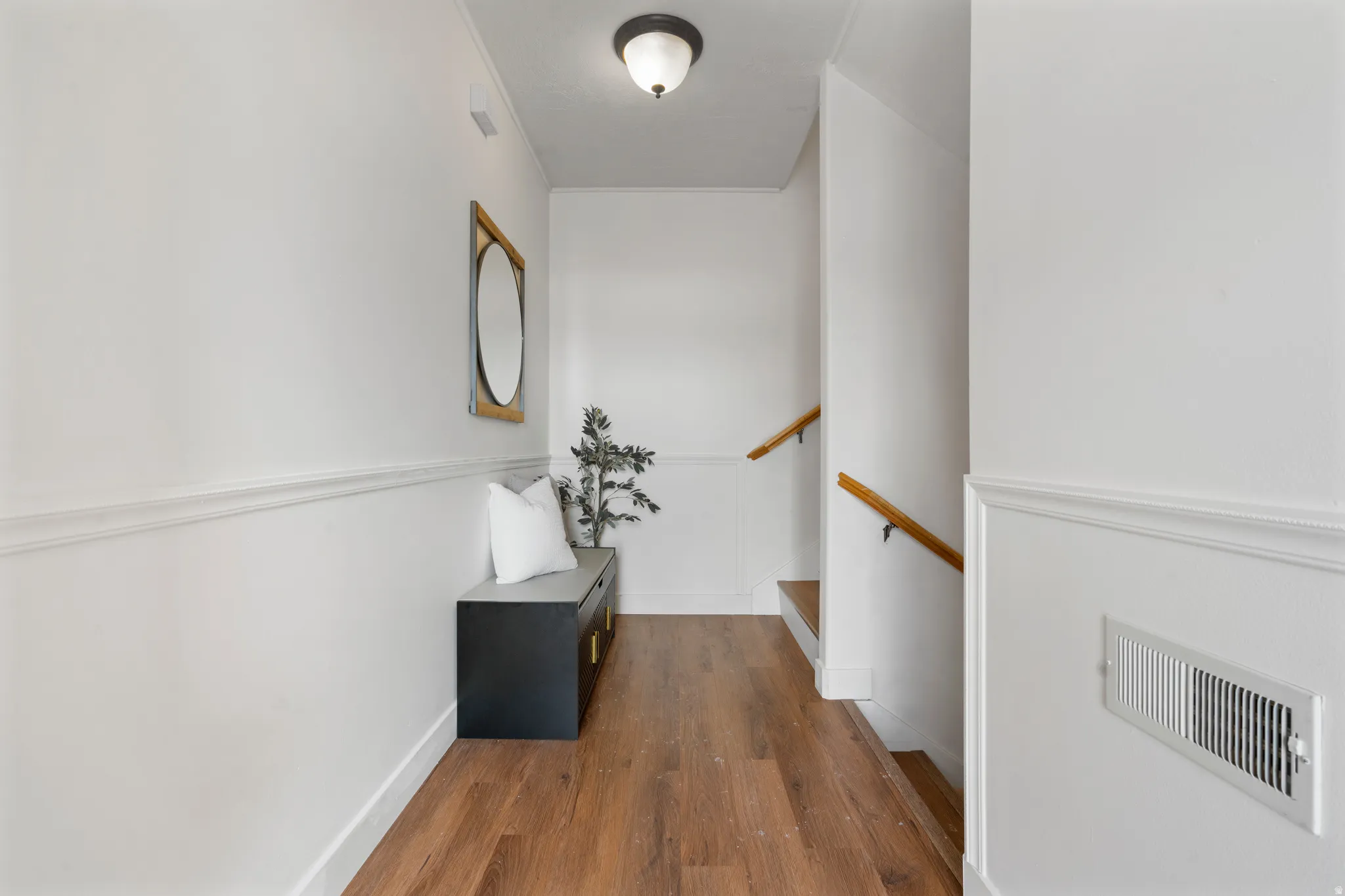 Entry hall with dark wood-type flooring and baseboards