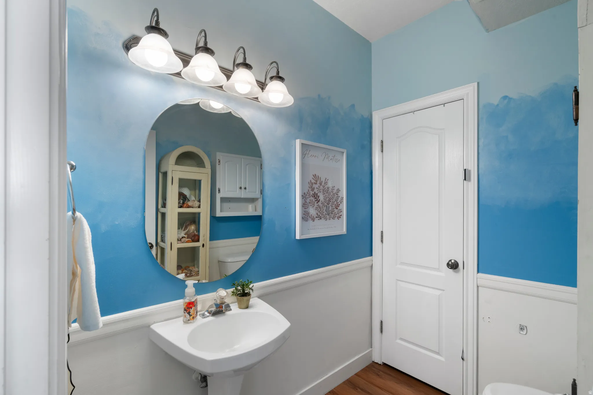 Bathroom with toilet and wood finished floors
