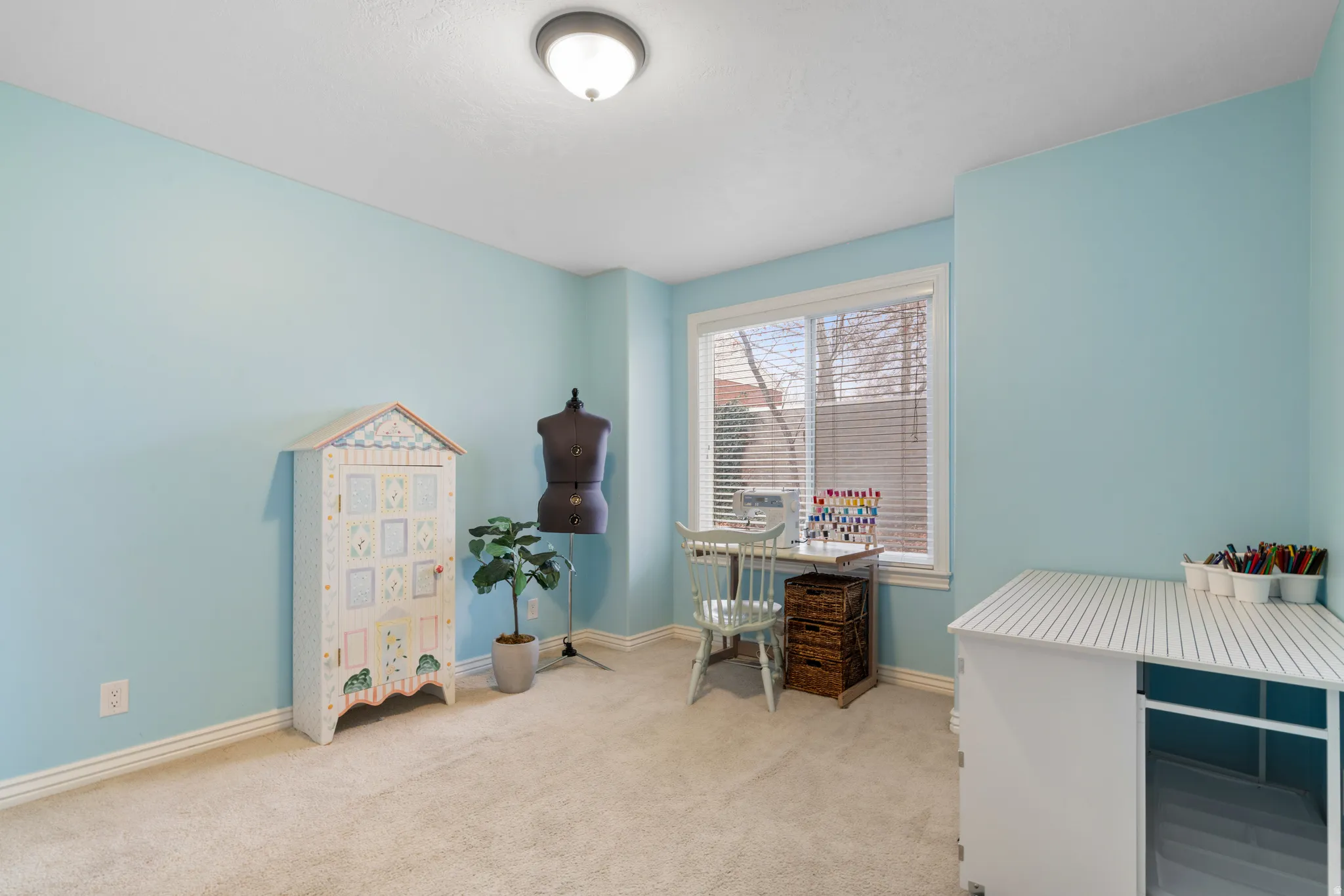 Office area featuring baseboards and light colored carpet