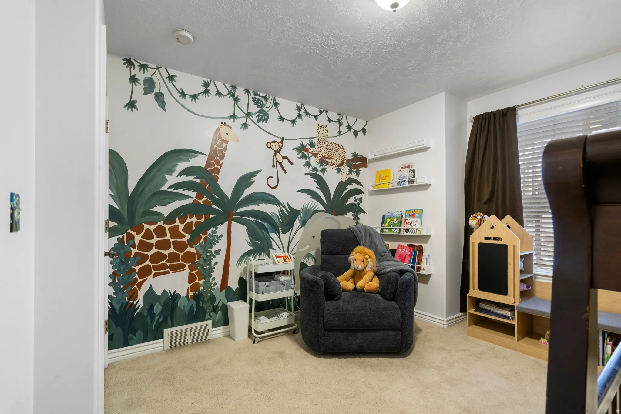 Living area featuring carpet and a textured ceiling