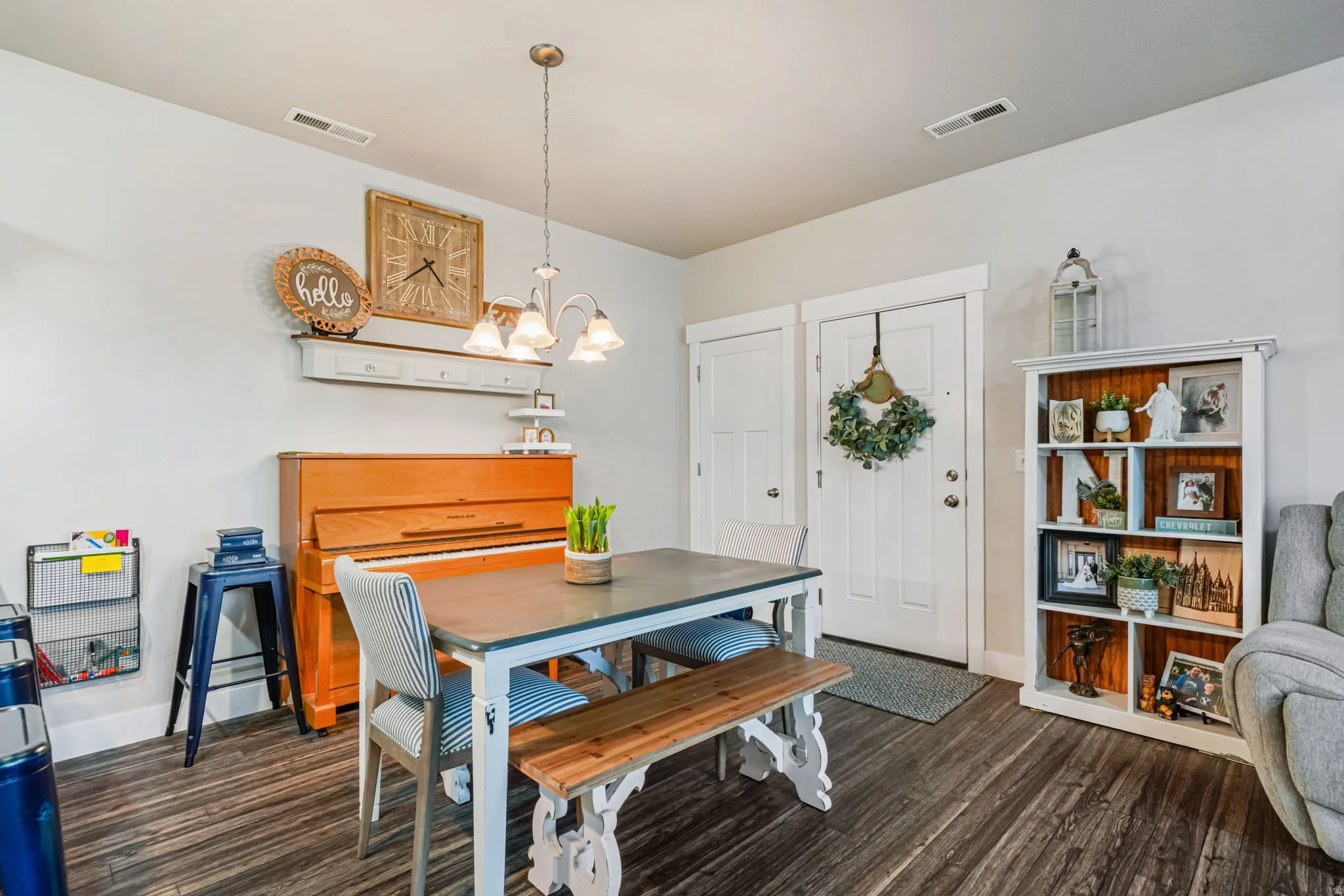 Dining space with a chandelier and dark wood finished floors