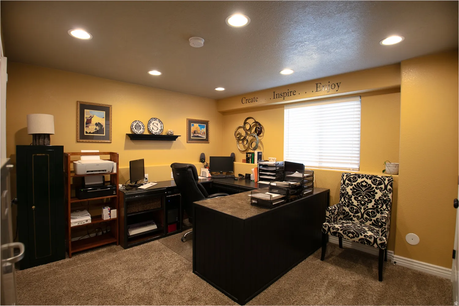 Downstairs bedroom currently being used as an office, featuring two large closets, recessed lighting and daylight window.