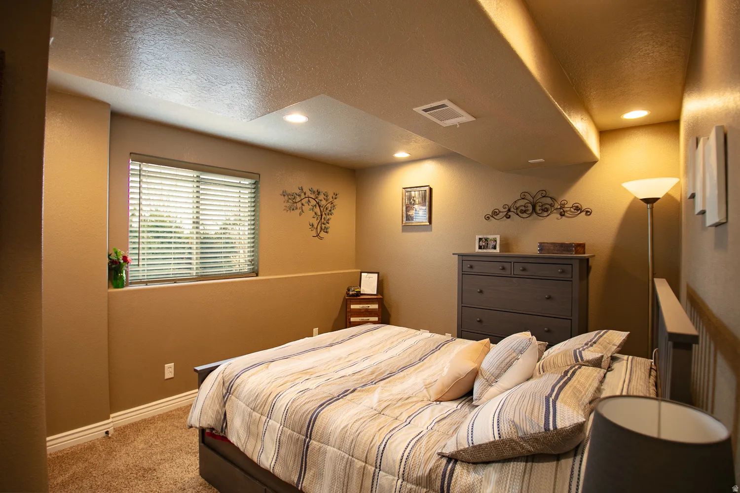 Downstairs bedroom with recessed lighting, daylight window and large closet.