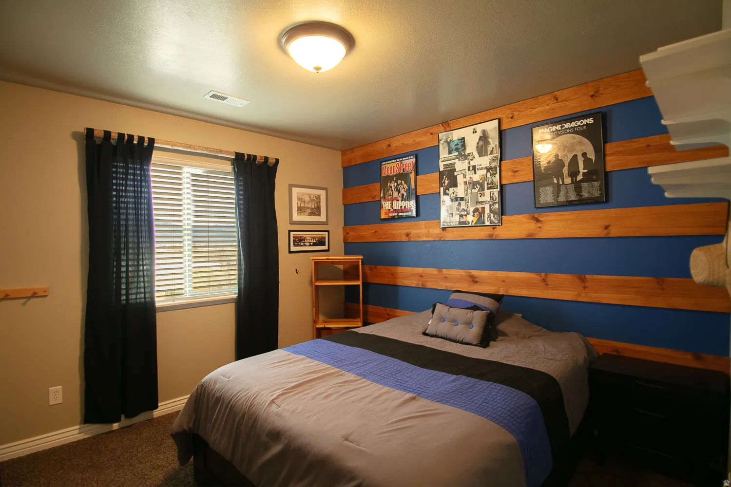 Bedroom featuring carpet floors and wooden walls