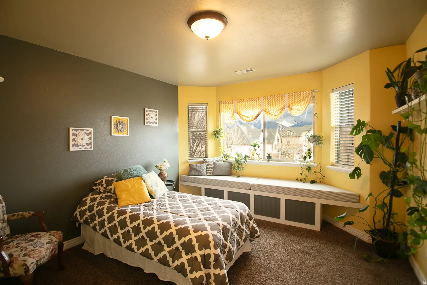 Bedroom featuring dark carpet and baseboards