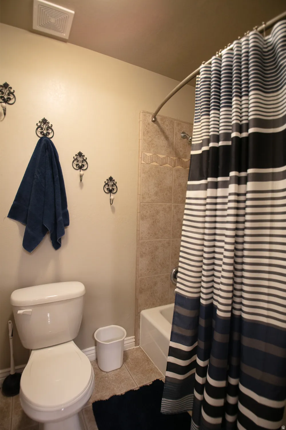 Full bathroom featuring light tile patterned flooring and shower / bath combination with curtain