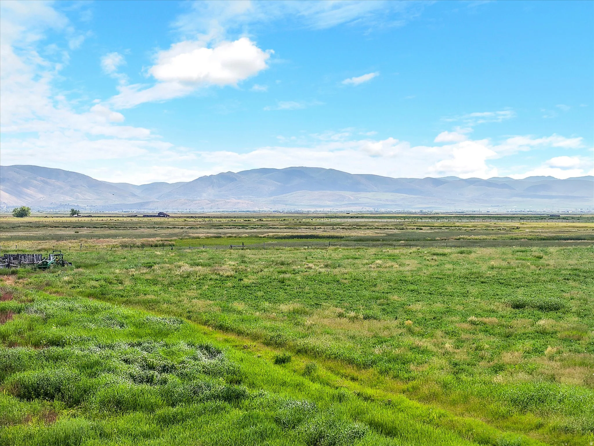 Expansive green landscape with distant mountains