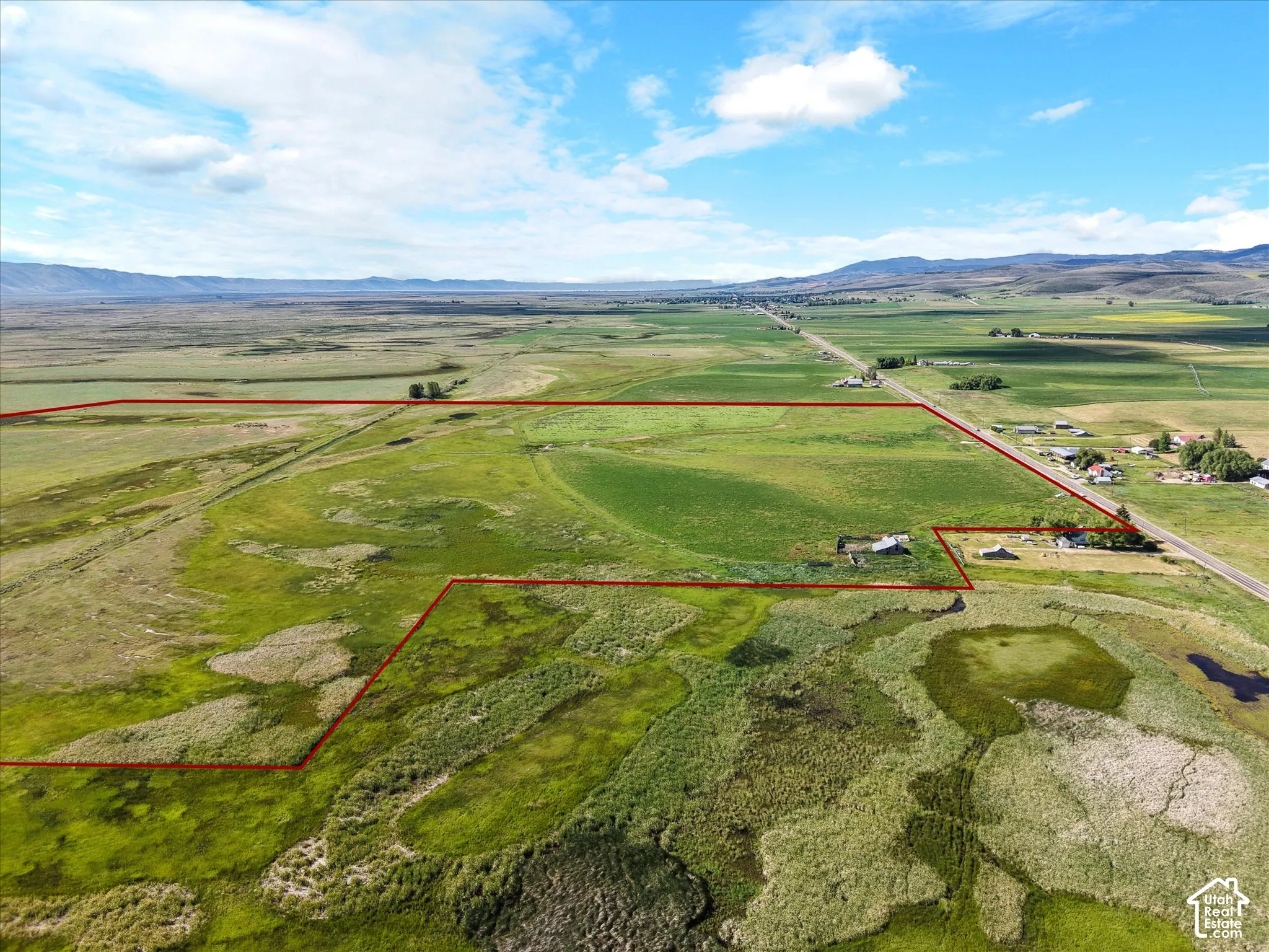 Expansive rural landscape featuring a mix of green fields
