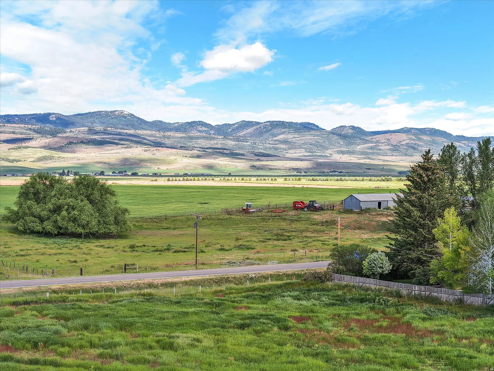 Expansive green fields with distant mountains