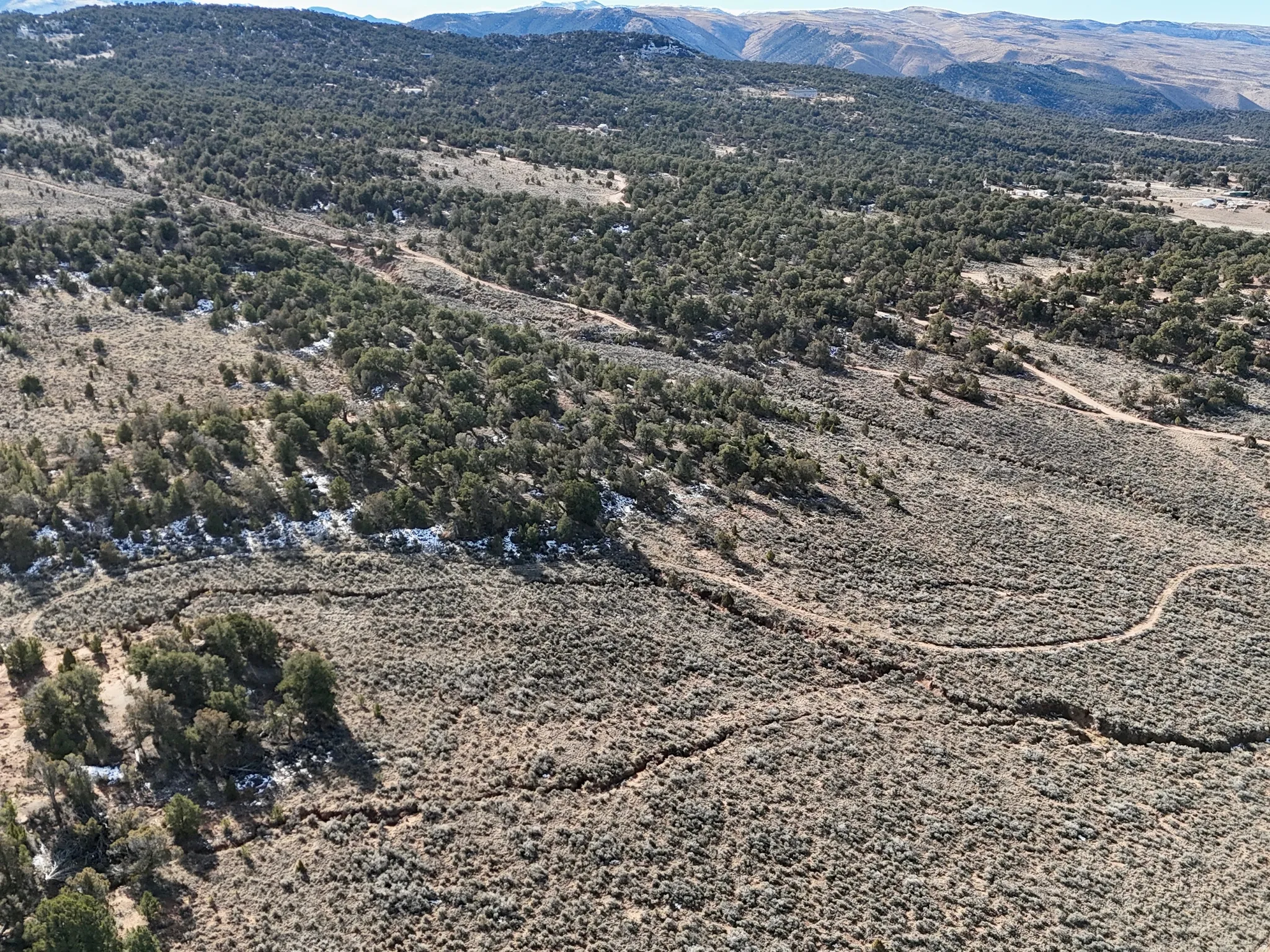 Aerial overview of property's location with a mountainous background