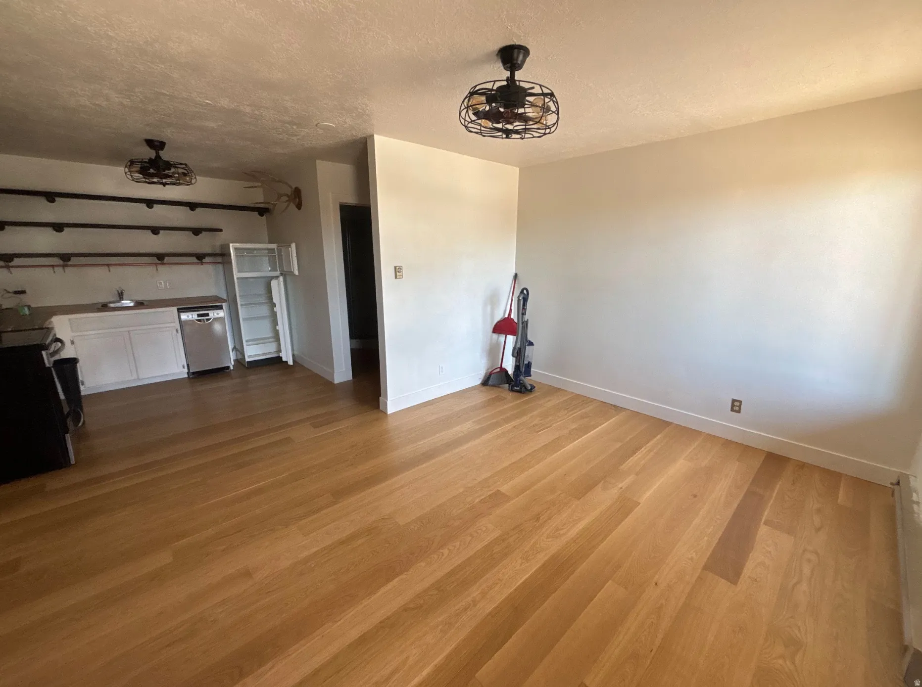 Unfurnished living room with a textured ceiling and light wood finished floors