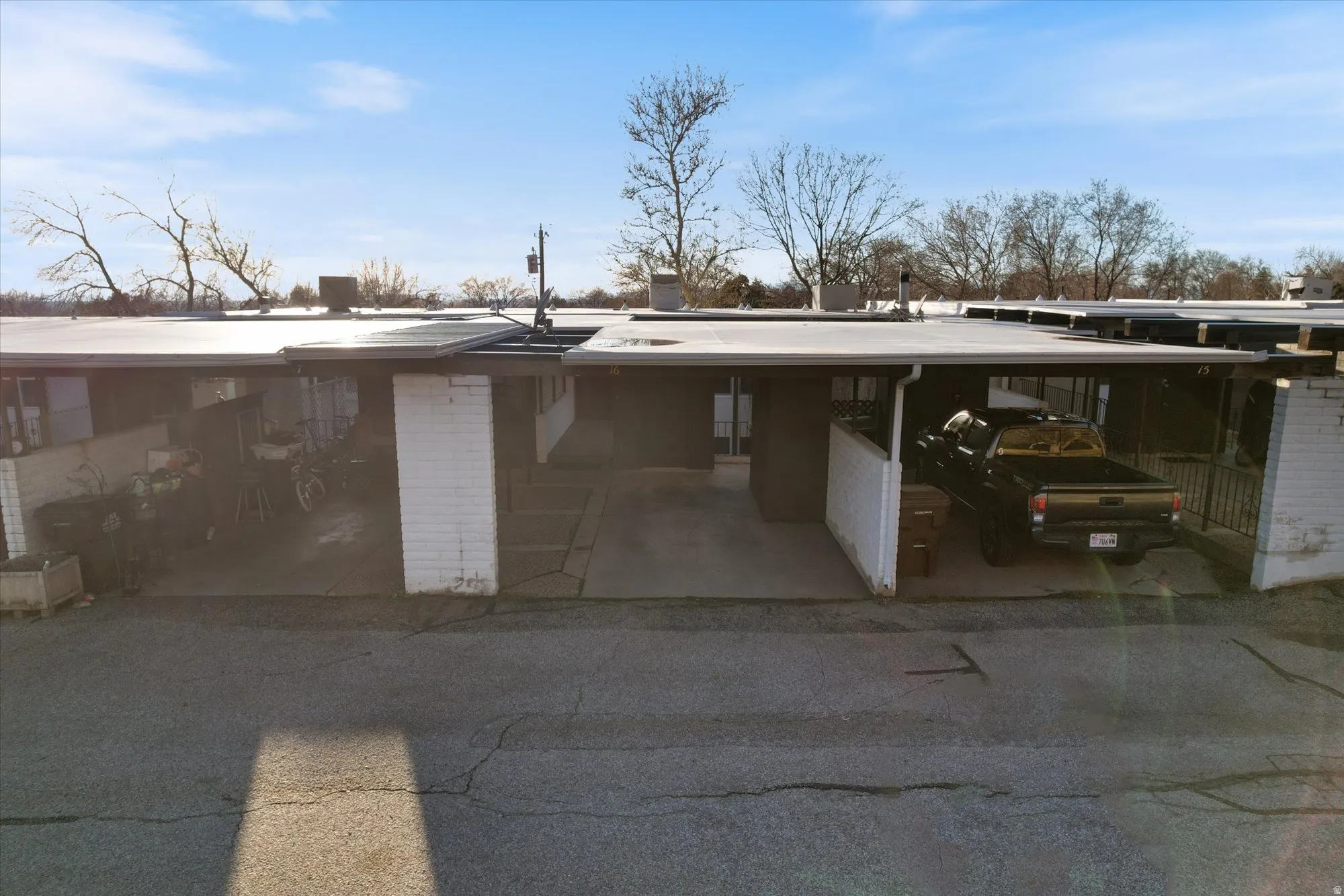 View of parking with an attached carport and driveway