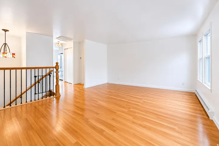 Bright interior space featuring polished wood-finish flooring