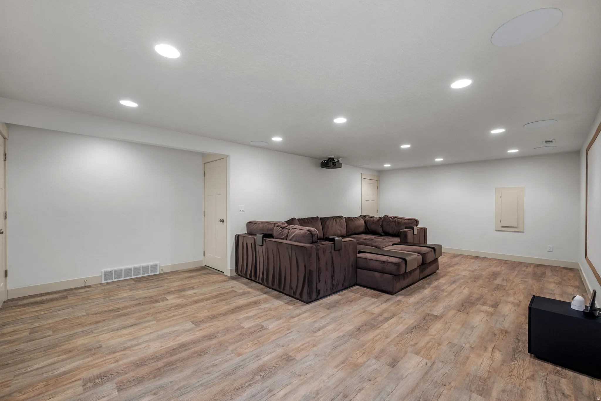 Living room featuring light wood-type flooring and recessed lighting