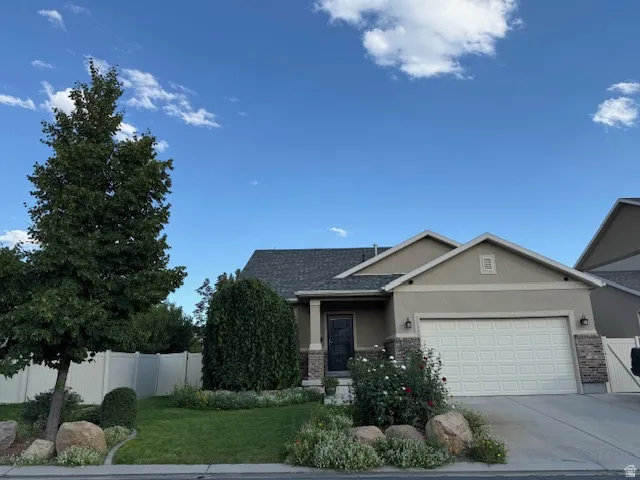 View of front of property with a garage, stucco siding, concrete driveway, roof with shingles, and covered porch