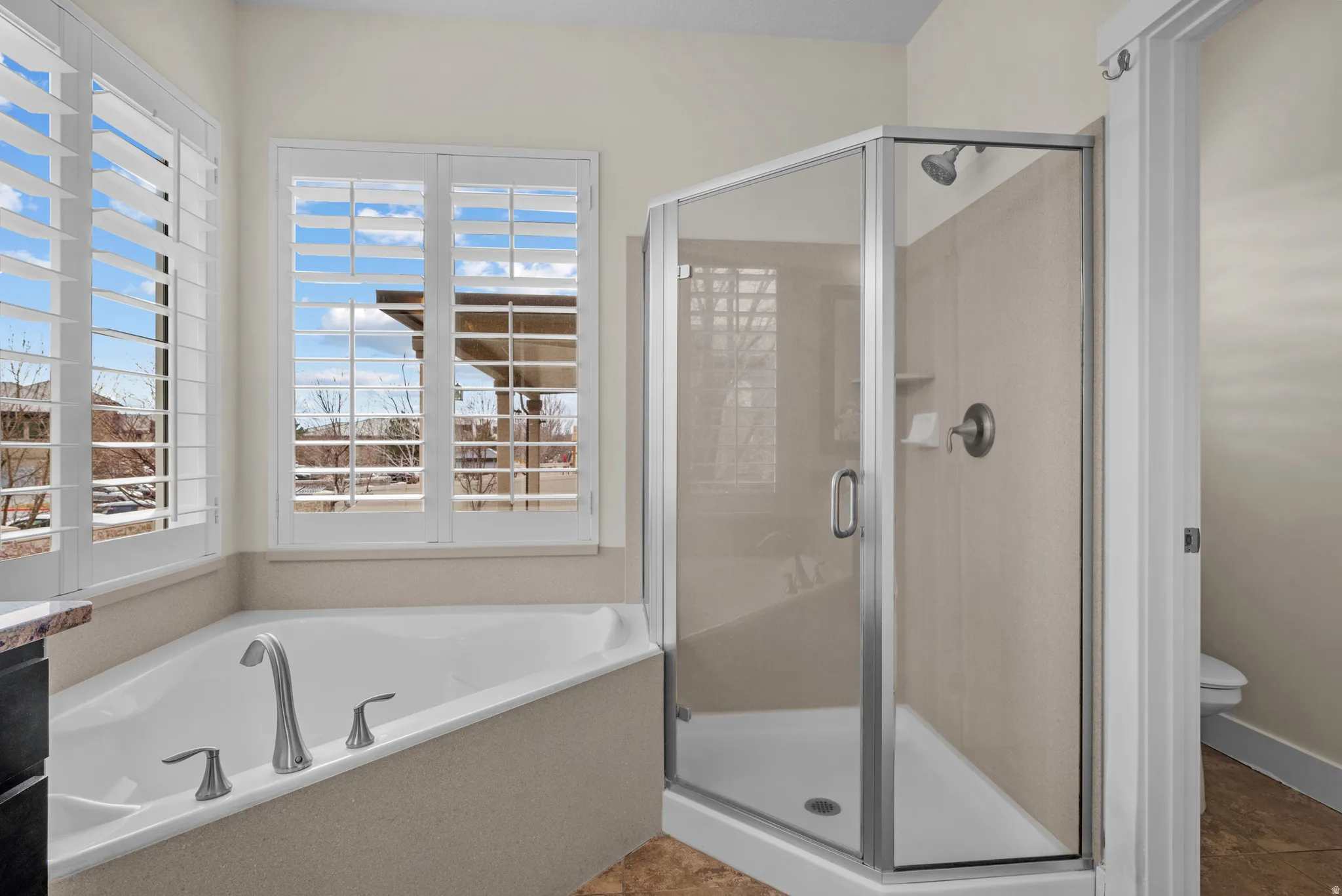 Bathroom with a stall shower and a garden tub