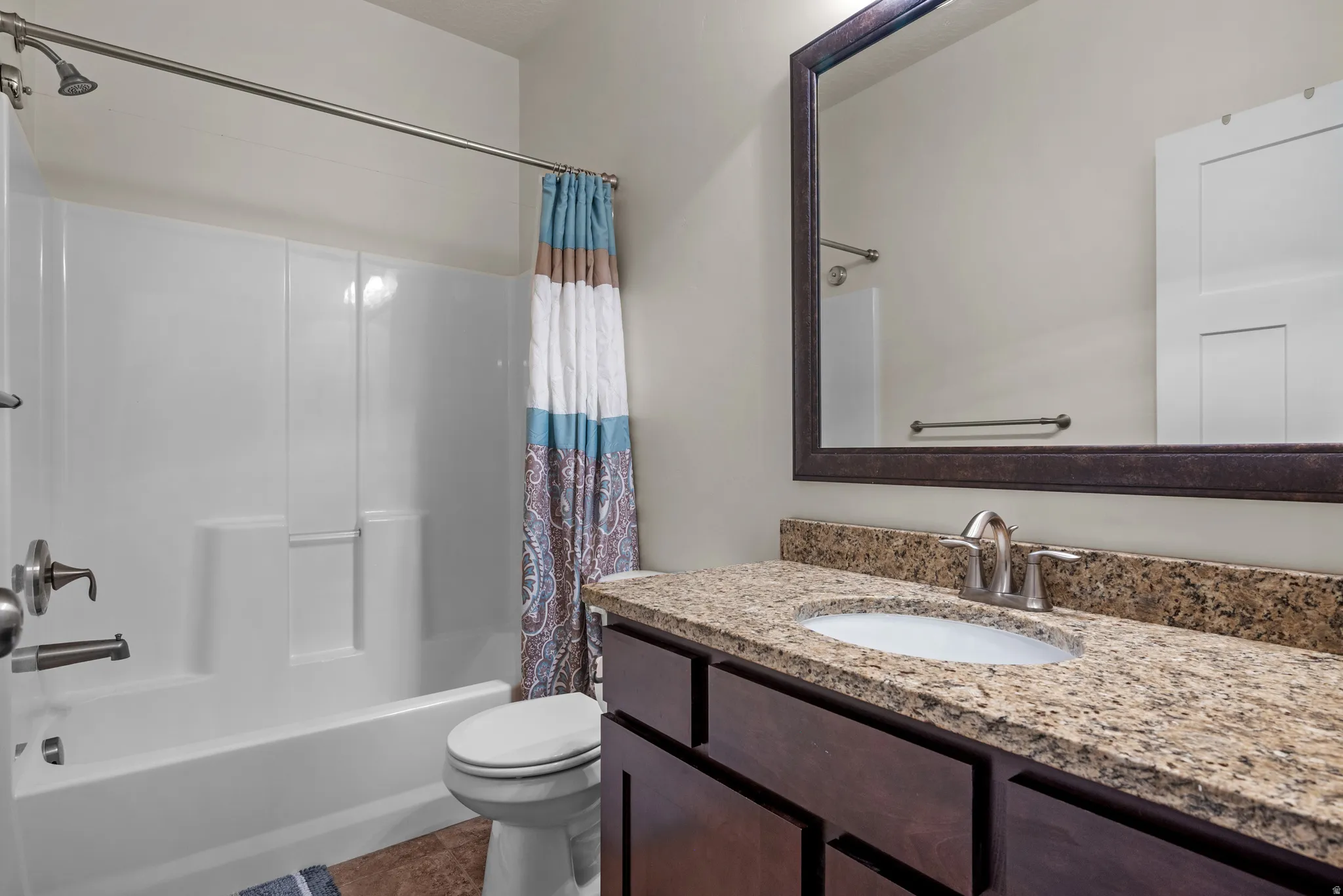 Bathroom with vanity and shower / bathtub combination with curtain