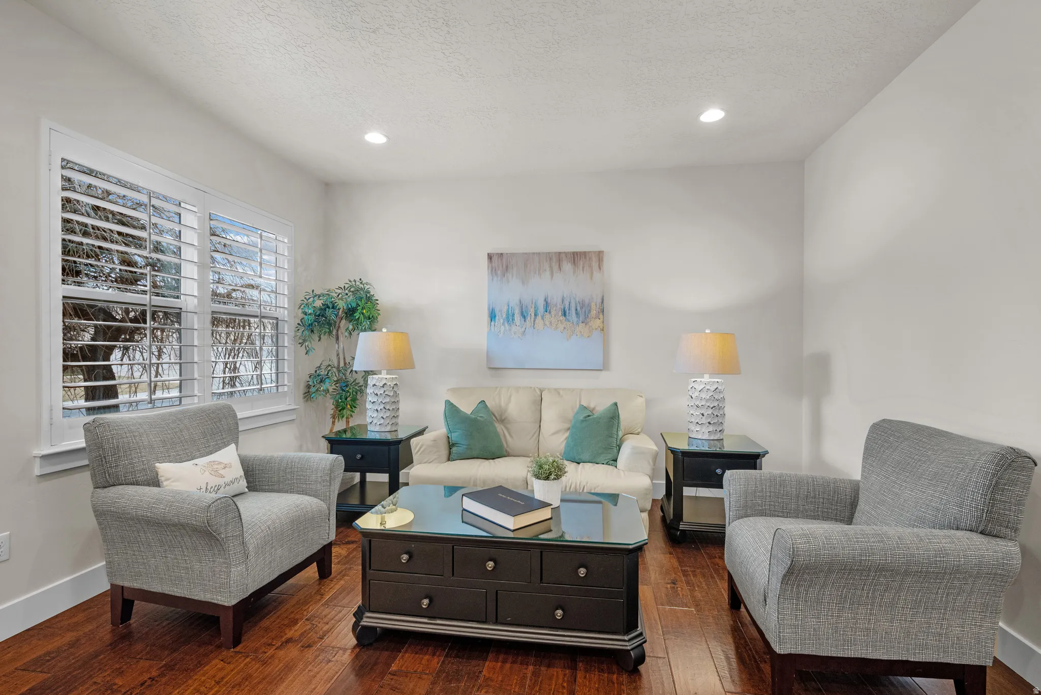 Living area featuring wood-type flooring, recessed lighting, and a textured ceiling