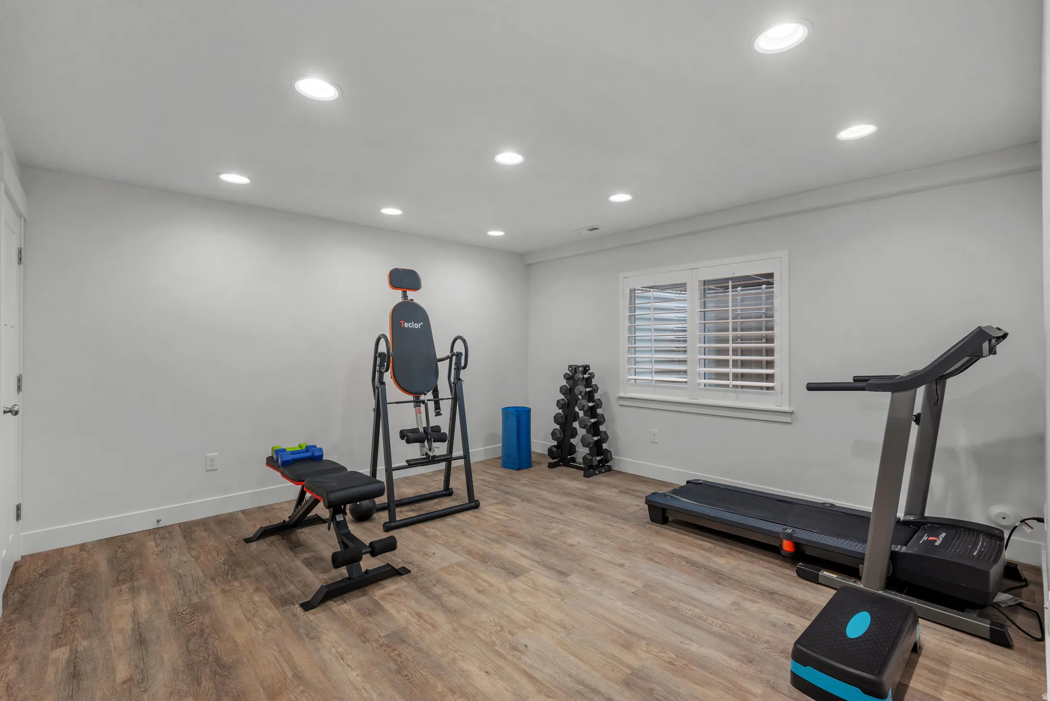 Workout area featuring recessed lighting and light wood-style flooring