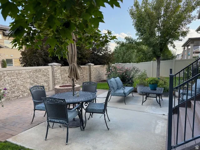 Fenced backyard with a patio area and outdoor dining area