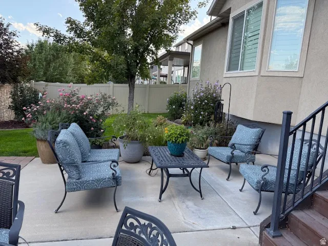 Fenced backyard featuring a patio and outdoor seating