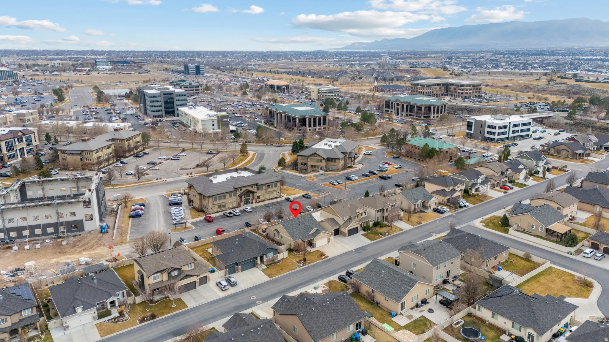 Aerial view of property's location featuring a mountain backdrop and nearby urban area