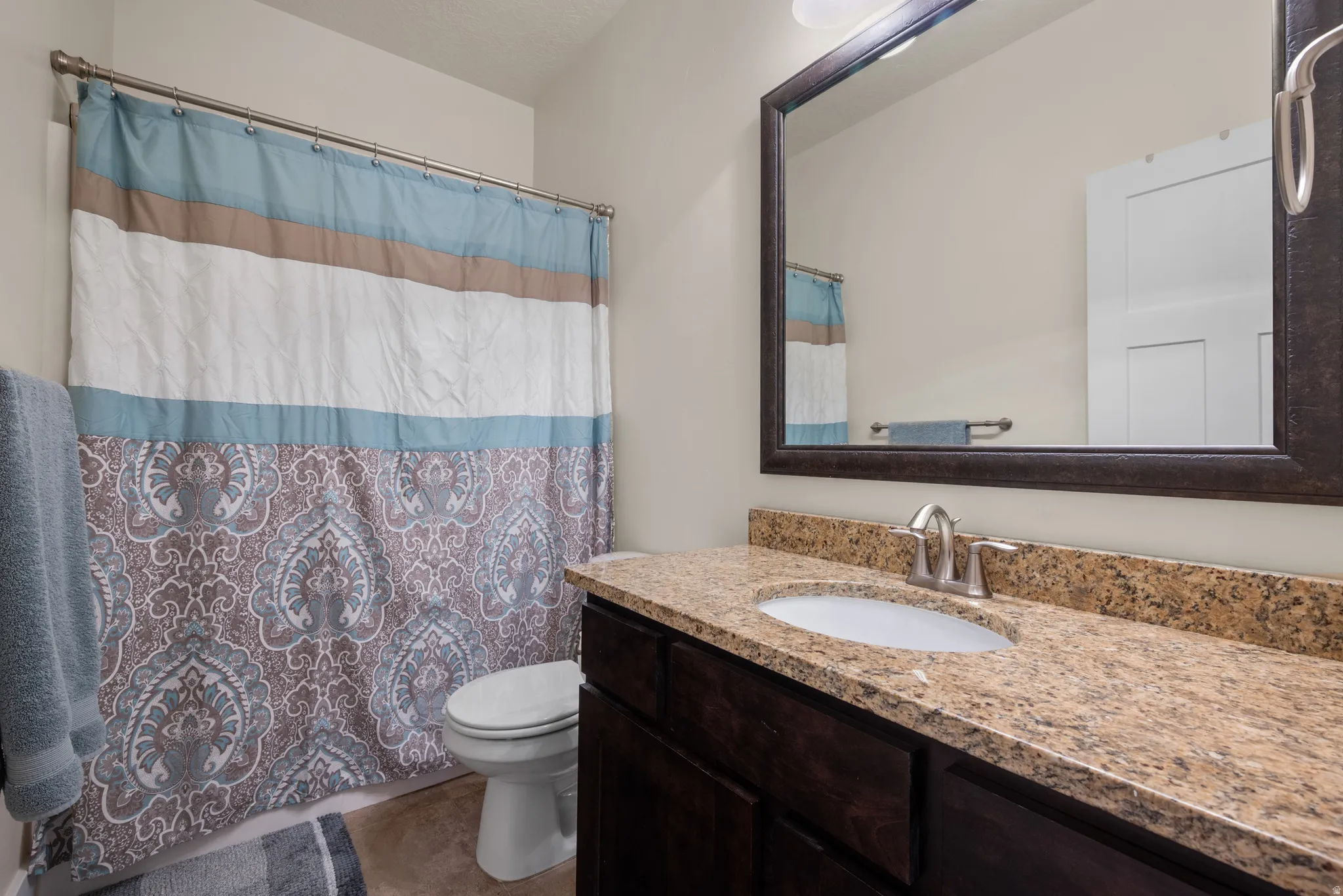 Bathroom featuring vanity and a shower with curtain