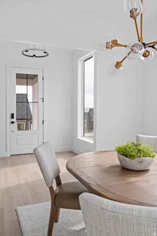 Open dining area featuring a wood-finish dining table and light wood-finish flooring