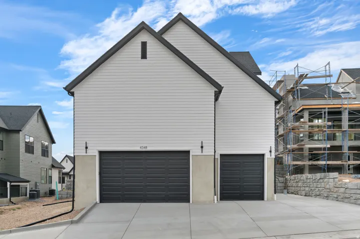 Modern exterior with light gray siding and dark gray trim