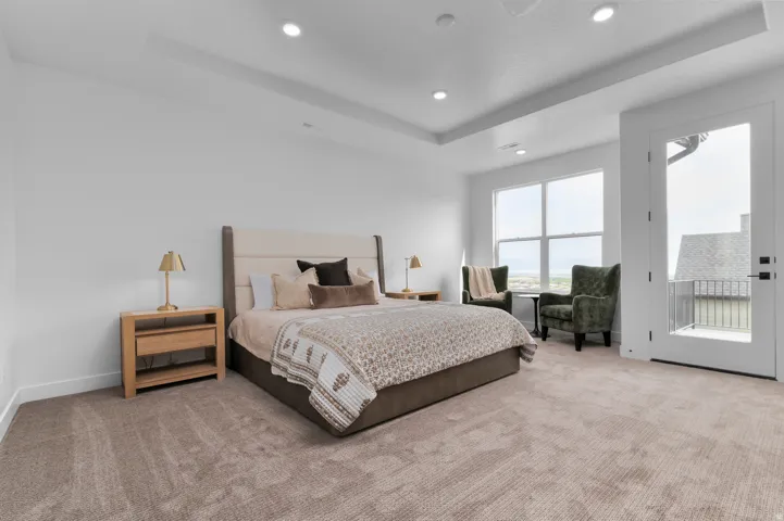 Recessed lighting illuminating a spacious room with light-toned carpet