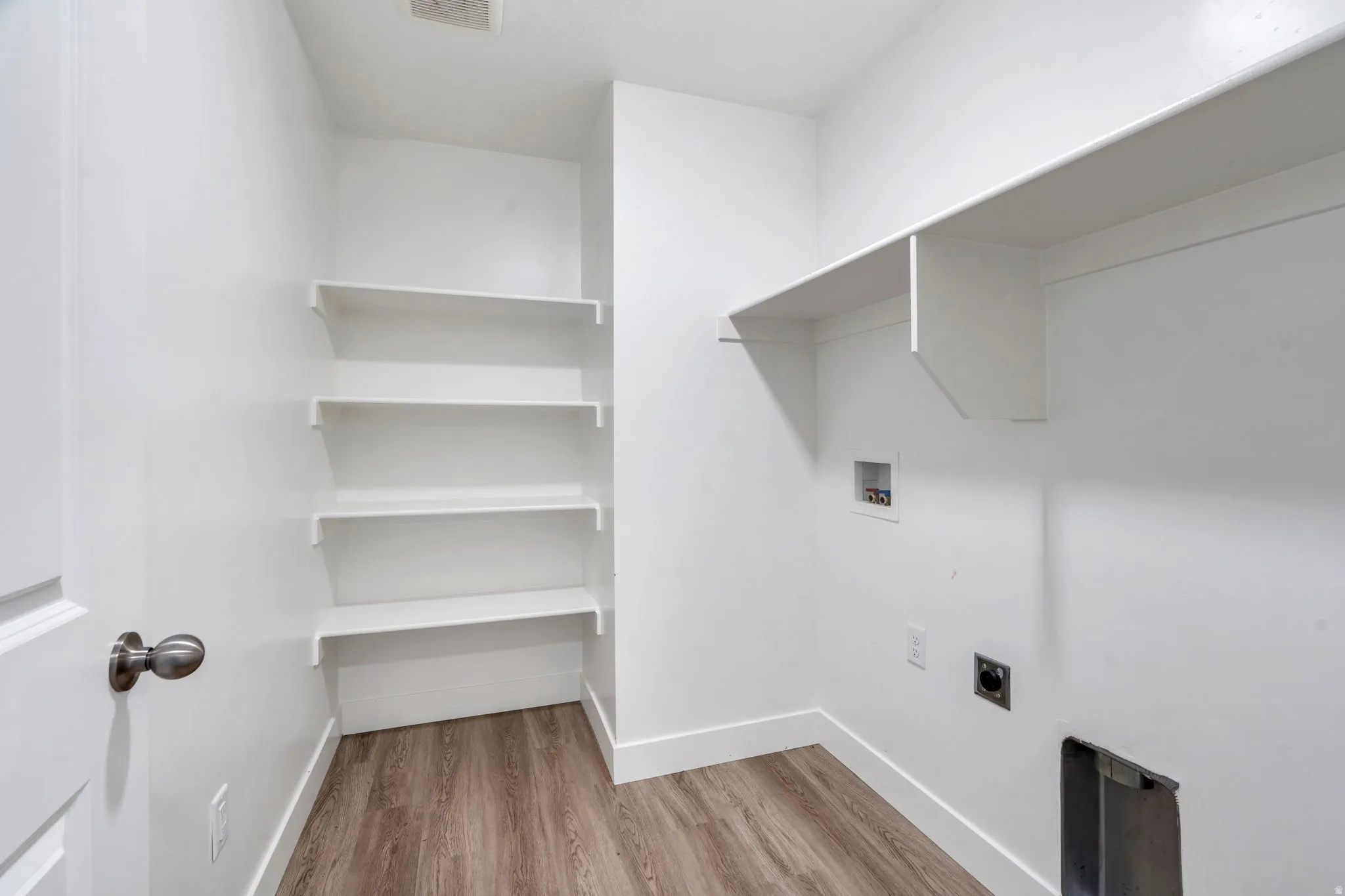 Laundry room with light wood-type flooring, electric dryer hookup, and hookup for a washing machine