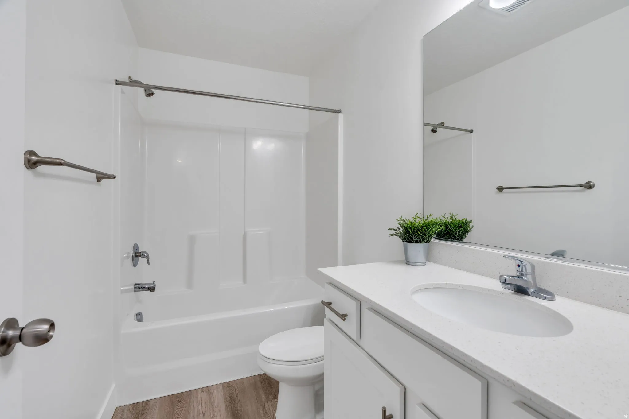 Full bathroom with vanity, light wood finished floors, and shower / tub combination